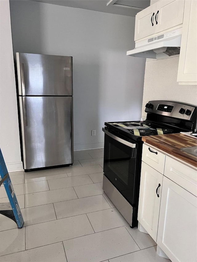 708 N Tennessee St, Mckinney, TX 75069 - kitchen featuring appliances with stainless steel finishes, under cabinet range hood, wooden counters, white cabinetry, and light tile patterned flooring