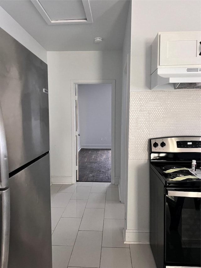 708 N Tennessee St, Mckinney, TX 75069 - kitchen featuring electric range oven, freestanding refrigerator, baseboards, and white cabinets