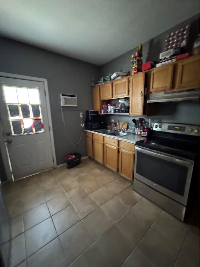 708 N Tennessee St, Mckinney, TX 75069 - kitchen with stainless steel range with electric stovetop, under cabinet range hood, a sink, light tile patterned flooring, and a wall mounted AC