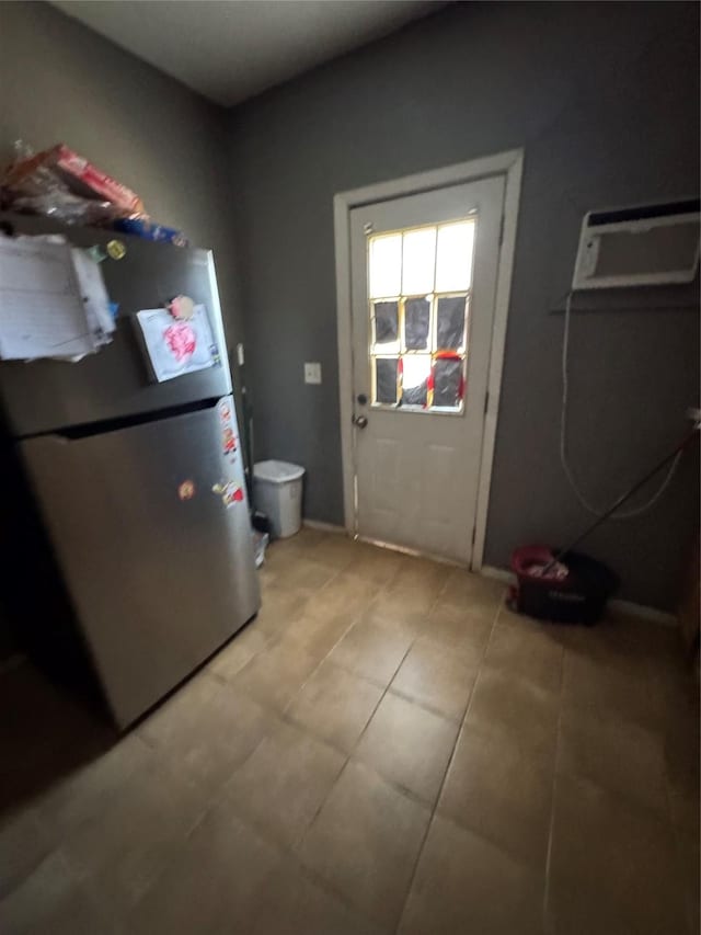 708 N Tennessee St, Mckinney, TX 75069 - doorway to outside with light tile patterned flooring, an AC wall unit, and baseboards