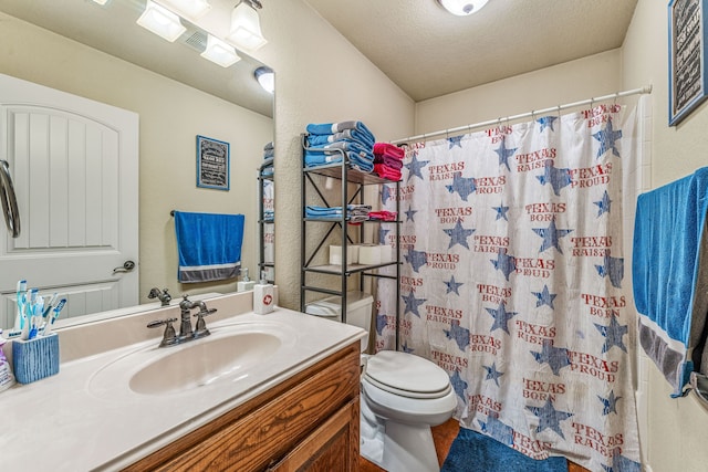 bathroom with a shower with shower curtain, toilet, and vanity
