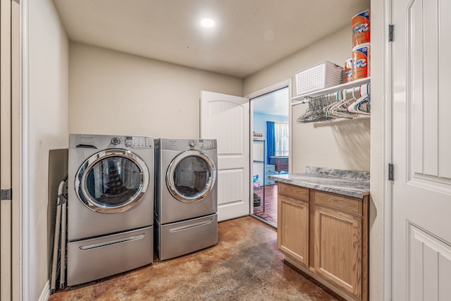 clothes washing area with independent washer and dryer and laundry area