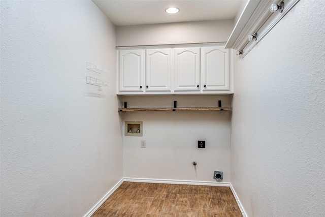 washroom featuring hookup for an electric dryer, hookup for a washing machine, baseboards, cabinet space, and gas dryer hookup