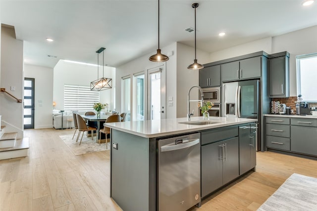 7320 Collin Mckinney Pkwy, Mckinney, TX 75070 - kitchen with light countertops, a sink, appliances with stainless steel finishes, and a healthy amount of sunlight