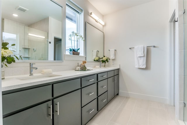 7320 Collin Mckinney Pkwy, Mckinney, TX 75070 - bathroom featuring a sink, double vanity, a stall shower, baseboards, and visible vents