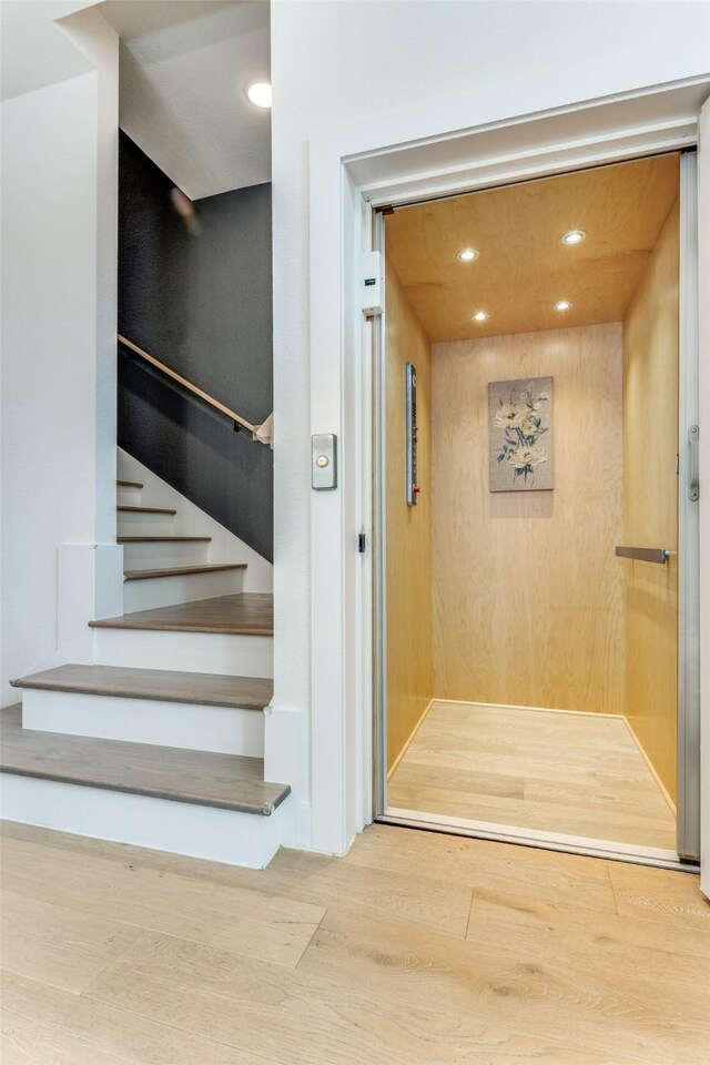 7320 Collin Mckinney Pkwy, Mckinney, TX 75070 - staircase featuring elevator, wood finished floors, and recessed lighting