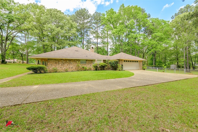 3873 Talton St, Shreveport, LA 71119 - ranch-style house with a front lawn, driveway, a chimney, fence, and an attached garage