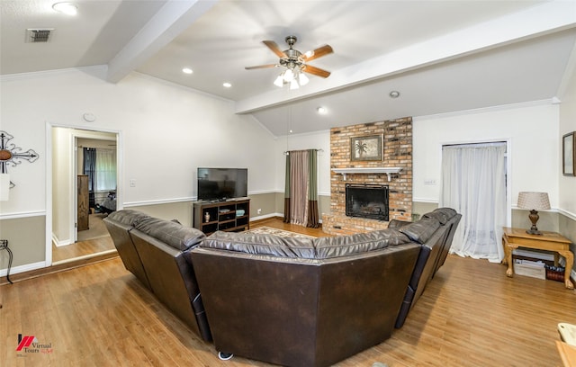 3873 Talton St, Shreveport, LA 71119 - living room with lofted ceiling with beams, light wood-type flooring, visible vents, a ceiling fan, and a brick fireplace