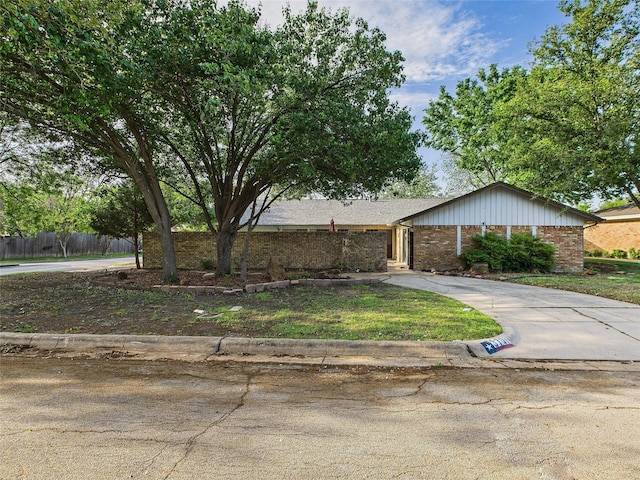 single story home featuring brick siding and fence