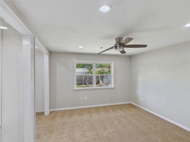 spare room featuring light colored carpet, baseboards, a ceiling fan, and recessed lighting