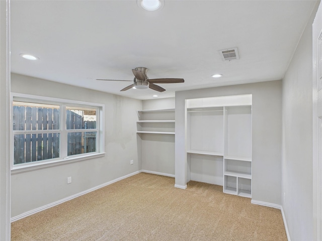 unfurnished bedroom featuring two closets, carpet, baseboards, visible vents, and recessed lighting