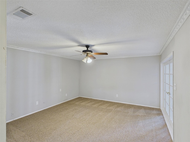 spare room with a textured ceiling, visible vents, light carpet, and ceiling fan
