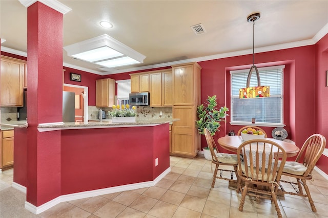 kitchen featuring crown molding, tasteful backsplash, stainless steel microwave, and refrigerator