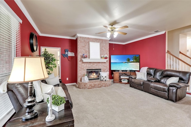 living room featuring a fireplace, carpet floors, a ceiling fan, visible vents, and ornamental molding