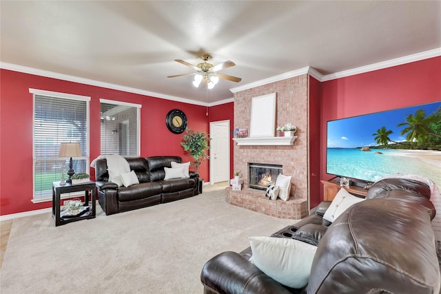 carpeted living room featuring crown molding, a ceiling fan, baseboards, and a fireplace