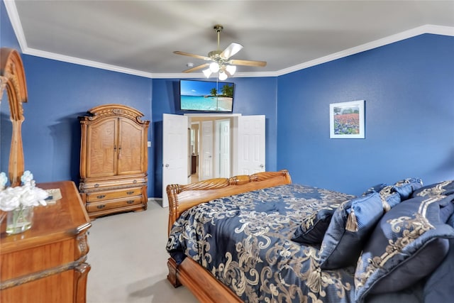 carpeted bedroom featuring ceiling fan and ornamental molding