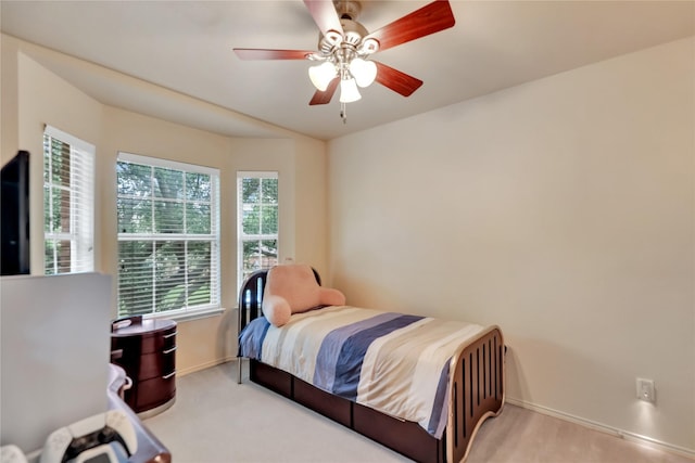 bedroom with baseboards, carpet, ceiling fan, and multiple windows
