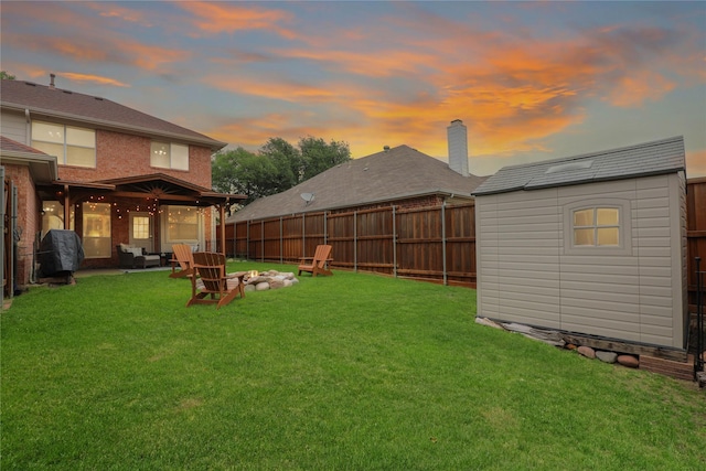view of yard with a fenced backyard, an outdoor structure, and a shed