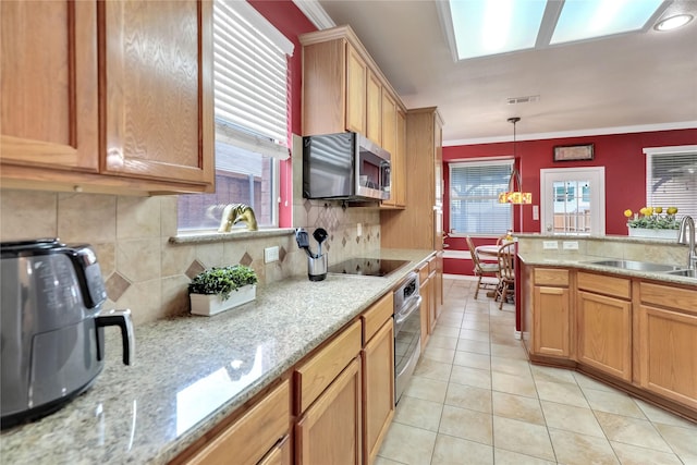 kitchen with a sink, appliances with stainless steel finishes, backsplash, and light tile patterned flooring
