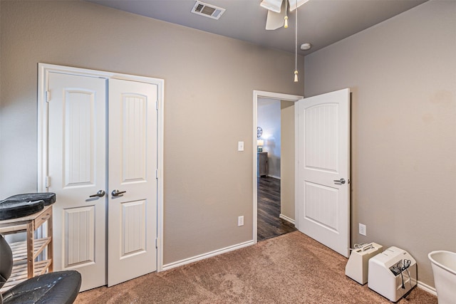 carpeted bedroom featuring baseboards, a ceiling fan, visible vents, and a closet