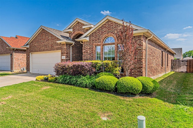 single story home featuring concrete driveway, a front lawn, an attached garage, fence, and brick siding