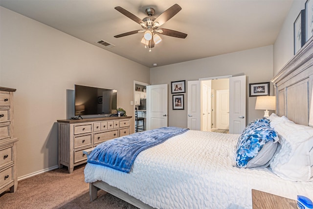 carpeted bedroom featuring baseboards, a ceiling fan, and visible vents