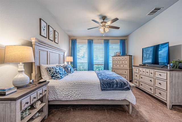 bedroom with a ceiling fan, visible vents, and carpet floors