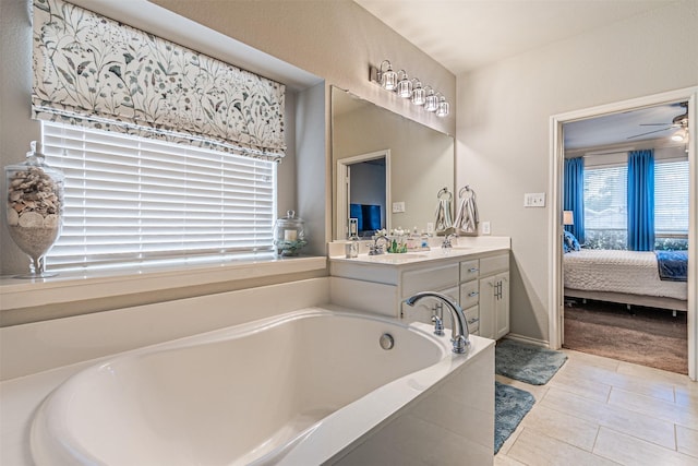 ensuite bathroom with tile patterned floors, double vanity, a sink, ensuite bath, and a garden tub