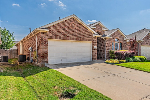 view of front facade with concrete driveway, an attached garage, brick siding, and central AC unit
