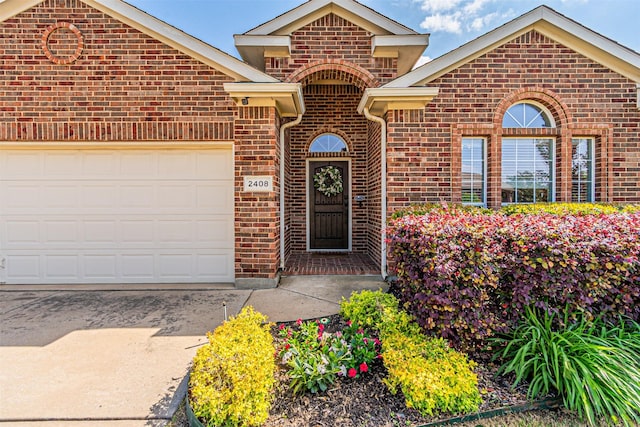 ranch-style home with driveway, brick siding, and a garage
