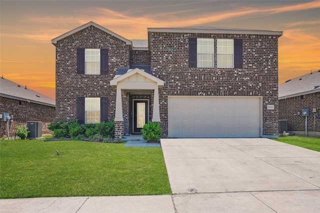 view of front of property with a front lawn, brick siding, and concrete driveway