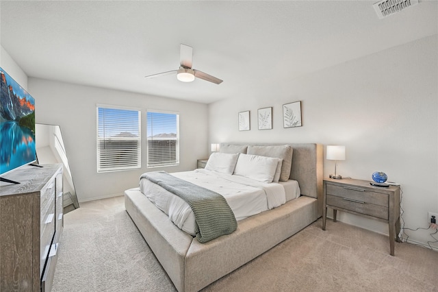 bedroom featuring light colored carpet, ceiling fan, baseboards, and visible vents