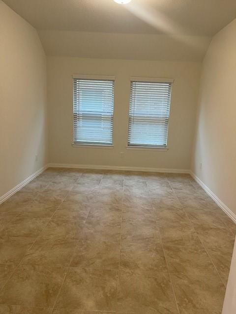 702 Grassland Way, Arlington, TX 76002 - spare room with vaulted ceiling and healthy amount of natural light