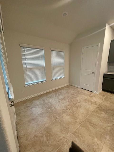 702 Grassland Way, Arlington, TX 76002 - spare room featuring lofted ceiling and baseboards