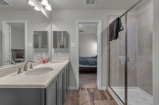 702 Grassland Way, Arlington, TX 76002 - ensuite bathroom featuring wood finished floors, double vanity, and a shower stall