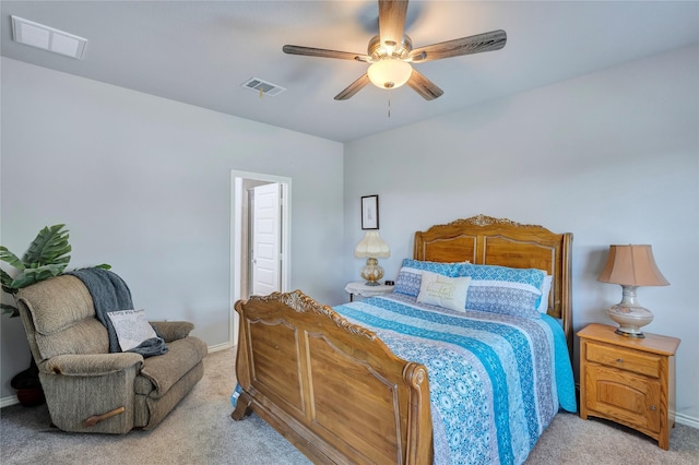 carpeted bedroom featuring visible vents, a ceiling fan, and baseboards