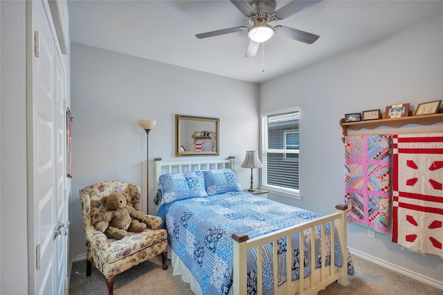 bedroom with a ceiling fan, baseboards, and carpet floors