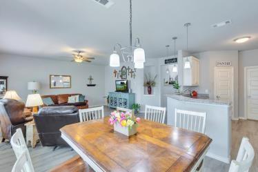 dining space with ceiling fan and light wood-type flooring