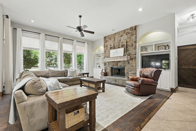 2204 Chipping Campden Rd, Denton, TX 76226 - tiled living room featuring ceiling fan, a fireplace, recessed lighting, and built in shelves