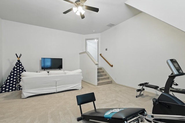 workout room with carpet floors, visible vents, and a ceiling fan