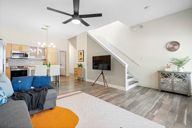 1823 S Ervay St, Dallas, TX 75215 - living room with light wood-style flooring, a ceiling fan, baseboards, stairway, and vaulted ceiling