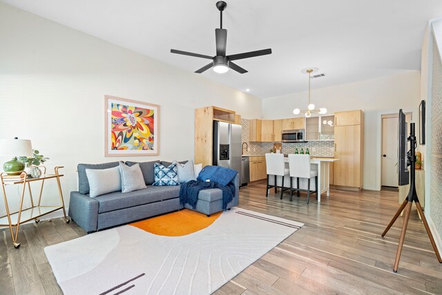 1823 S Ervay St, Dallas, TX 75215 - living room featuring light wood finished floors, a ceiling fan, and a chandelier