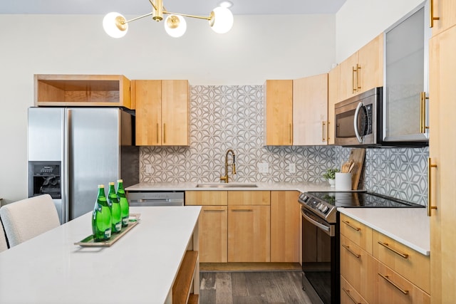 1823 S Ervay St, Dallas, TX 75215 - kitchen featuring stainless steel appliances, a sink, light countertops, light brown cabinets, and a chandelier
