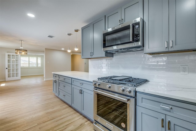 8494 Swift Ave, Dallas, TX 75228 - kitchen with appliances with stainless steel finishes, baseboards, gray cabinetry, light stone counters, and recessed lighting