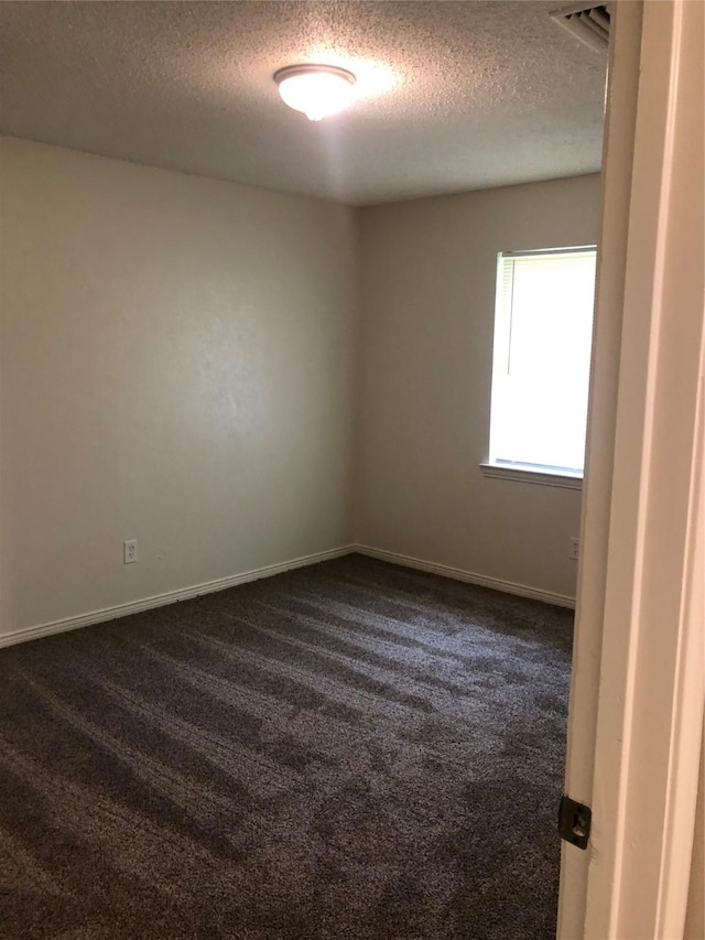 414 Brookview Dr, Desoto, TX 75115 - empty room with dark carpet, baseboards, a textured ceiling, and visible vents