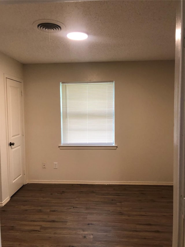 414 Brookview Dr, Desoto, TX 75115 - spare room featuring baseboards, a textured ceiling, and dark wood-type flooring