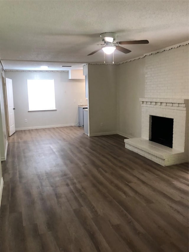 414 Brookview Dr, Desoto, TX 75115 - unfurnished living room with ceiling fan, baseboards, dark wood-type flooring, and a fireplace