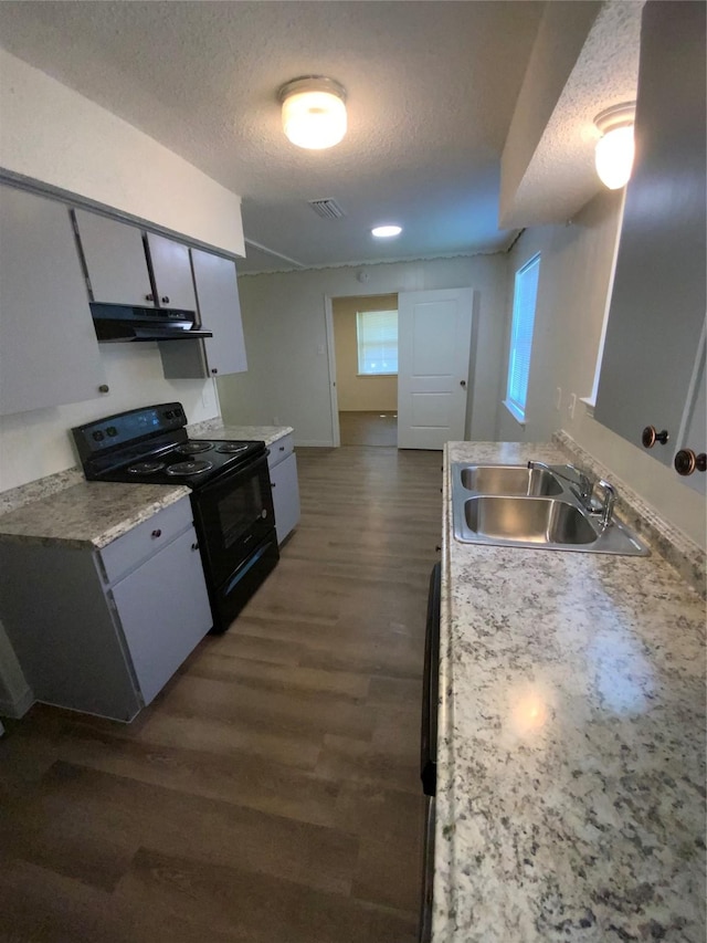 414 Brookview Dr, Desoto, TX 75115 - kitchen with a sink, black / electric stove, light countertops, dark wood-type flooring, and visible vents