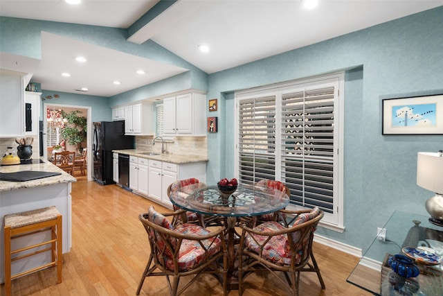 dining space with lofted ceiling with beams, recessed lighting, baseboards, and light wood-style flooring