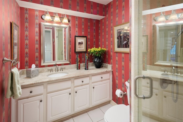 bathroom featuring a stall shower, toilet, wallpapered walls, tile patterned flooring, and vanity